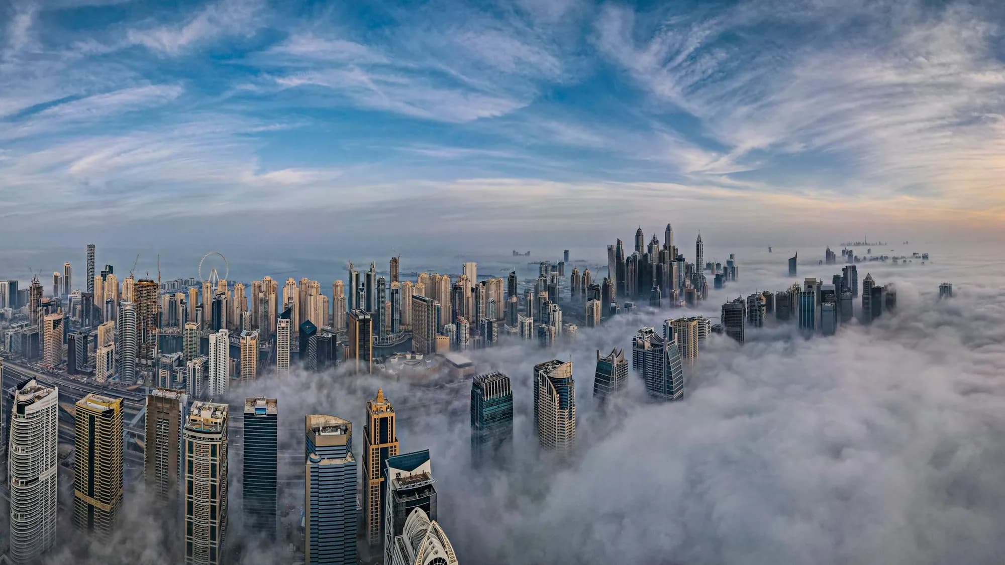 The towers of Sheikh Zayed Road, Dubai, rising above morning fog