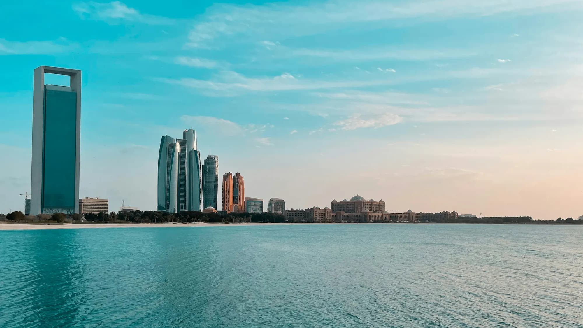 The Abu Dhabi skyline across the water: Etihad Towers and the ADNOC headquarters