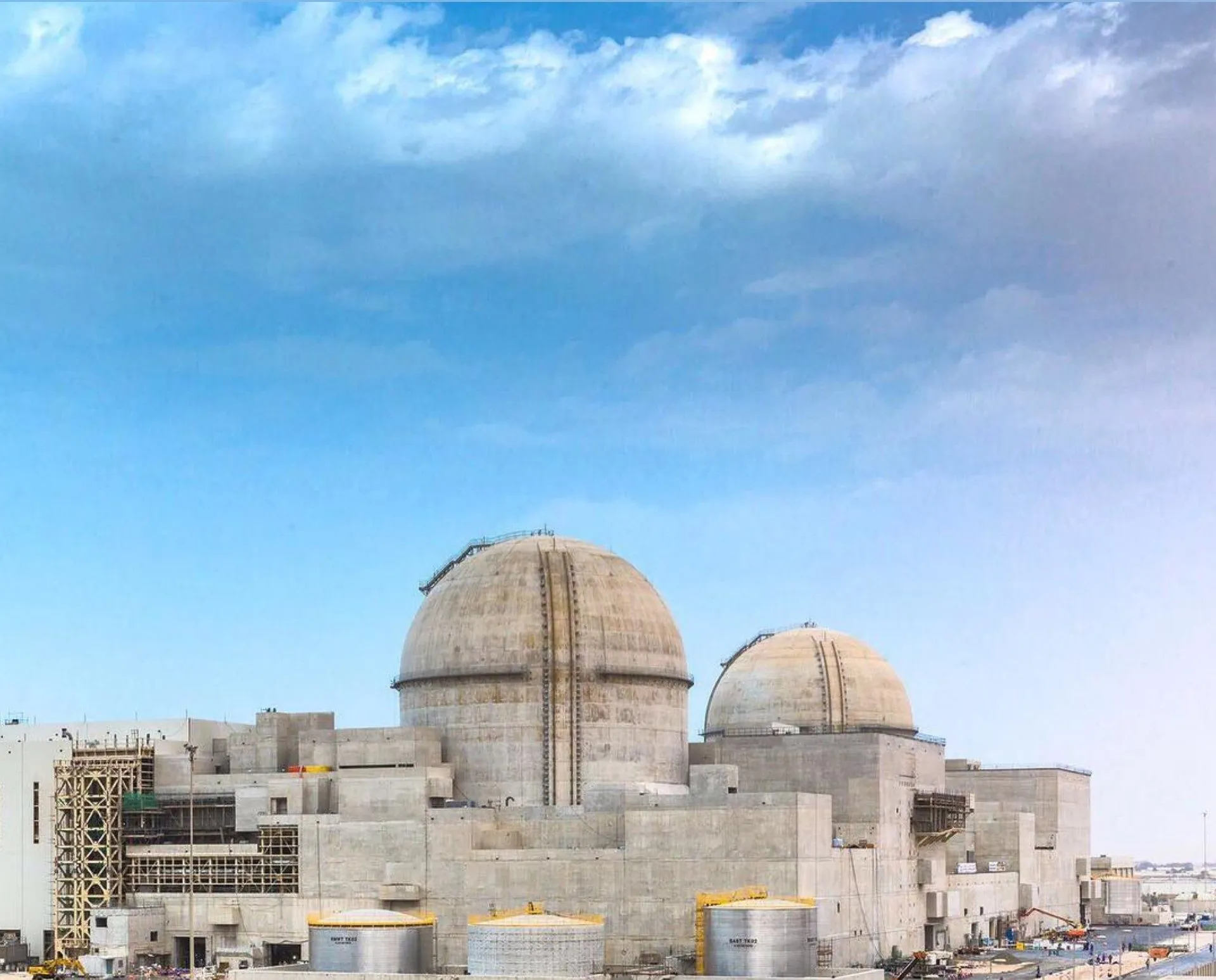 The reactor domes of the Barakah nuclear plant under a blue sky