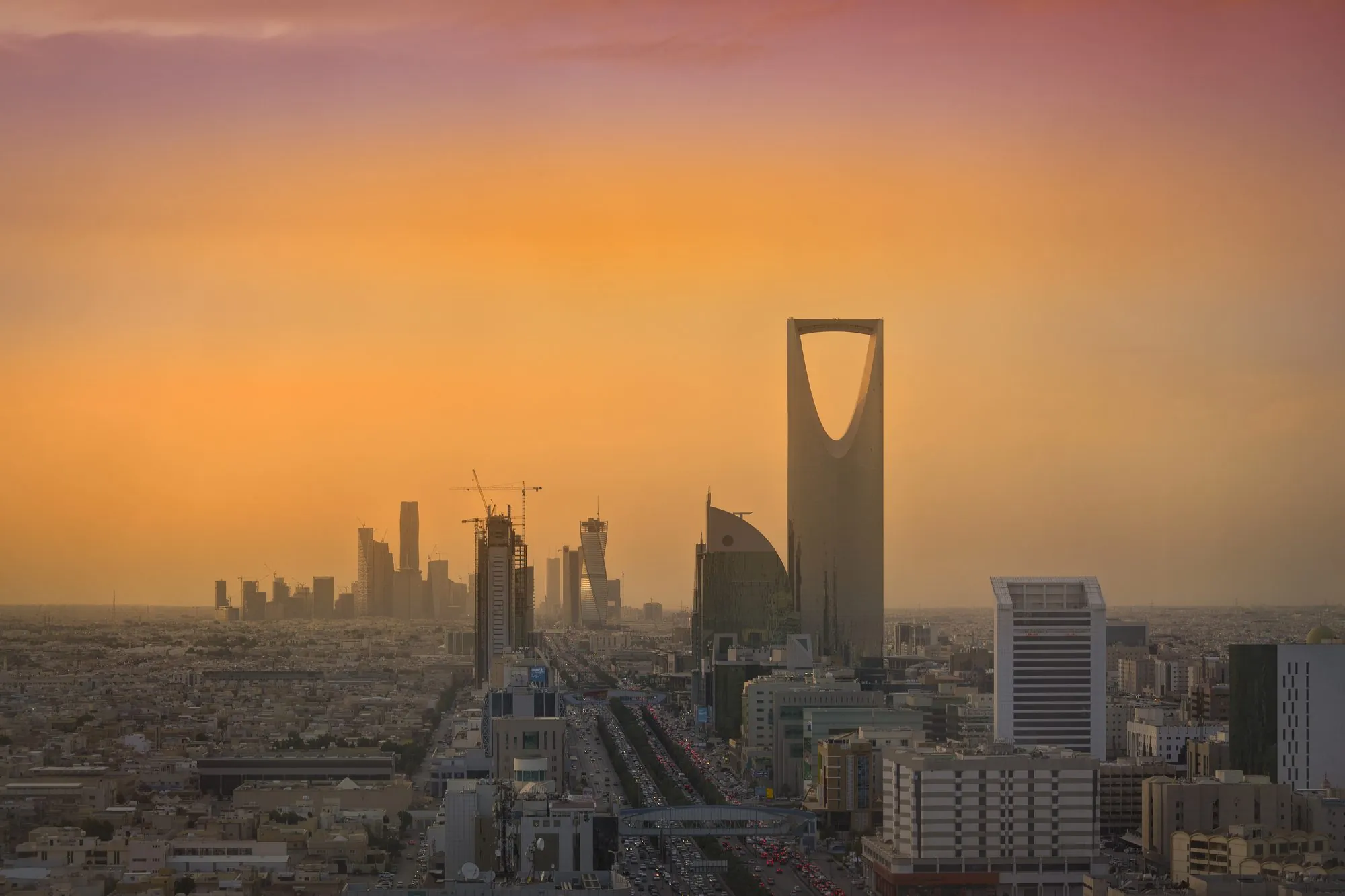 The Riyadh skyline at sunset, Kingdom Tower rising over the city