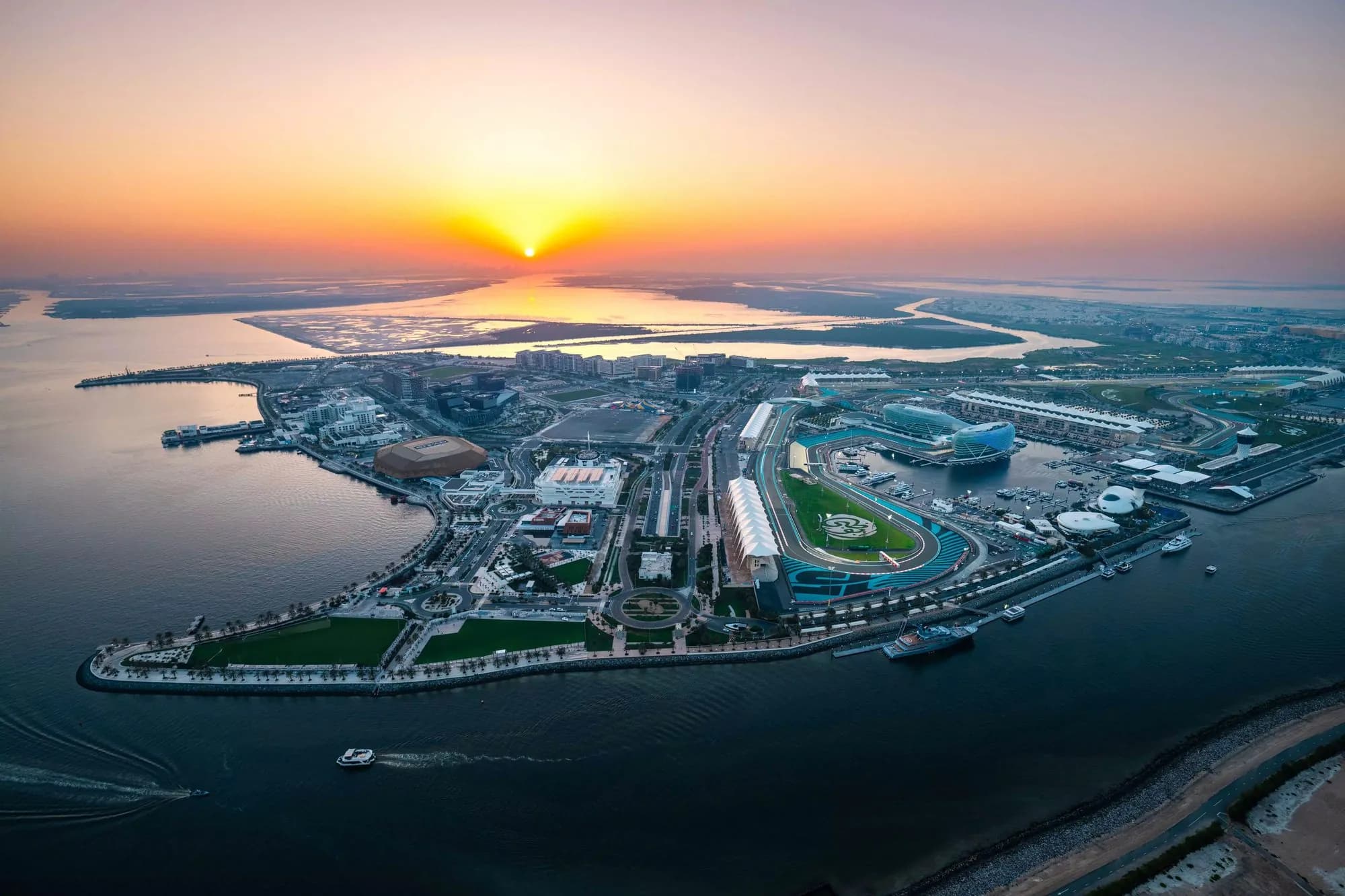 Yas Island from the air at sunset, Yas Marina Circuit and the Etihad Arena on the water